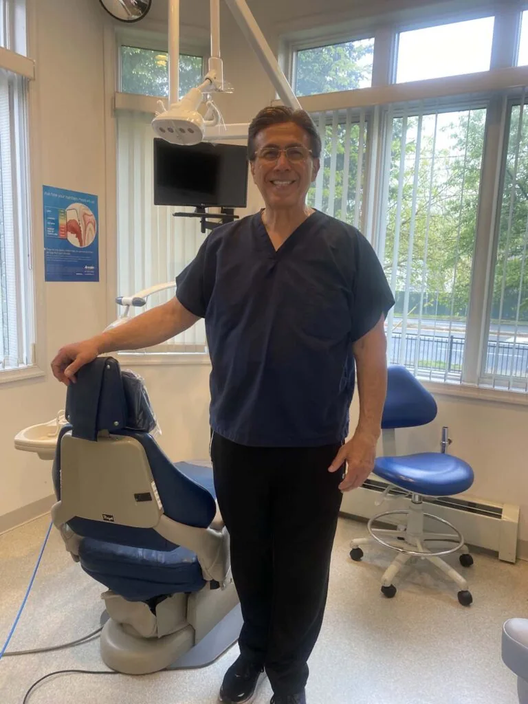 Dr. C. Anthony LoPresti standing in dental exam room smiling